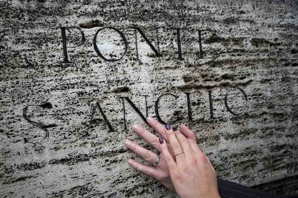 Hands and rings on the ancient marble of Castel Sant'Angelo.