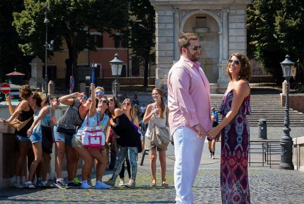 Engagement session during a group selfie in the background in the roman streets Italy.