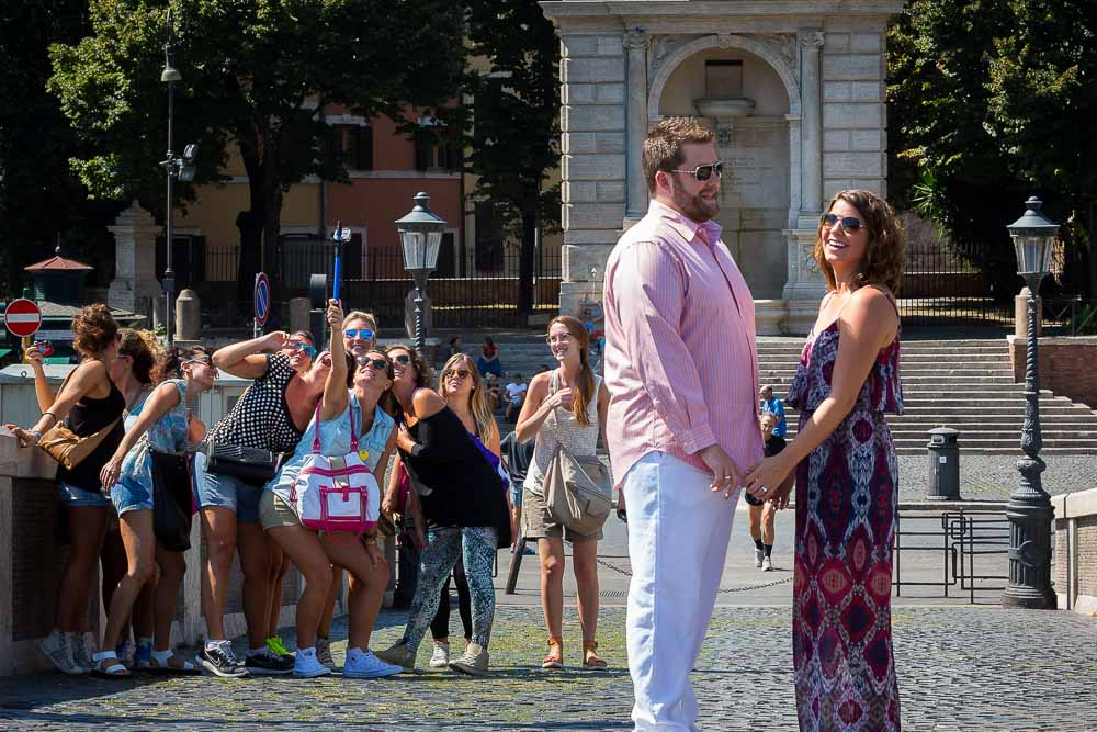 Engagement session during a group selfie in the background in the roman streets Italy.