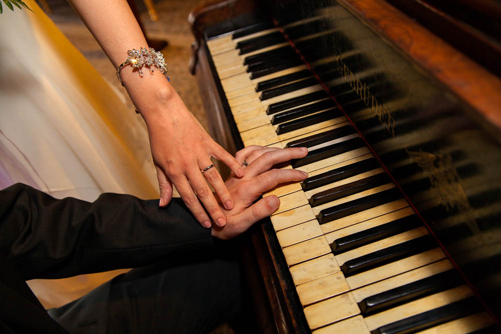 Hands playing on piano