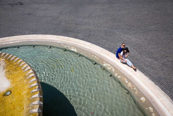 Engagement photo session in Rome by the Piazza del Popolo water fountain.