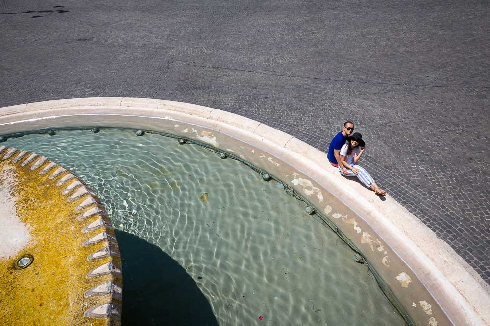 Engagement photo session in Rome by the Piazza del Popolo water fountain.