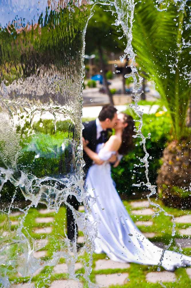 Wedding photo session behind water fall.