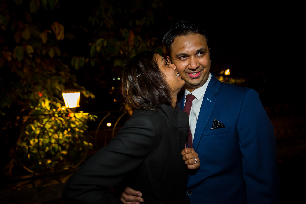 Couple kissing after a romantic night time wedding proposal