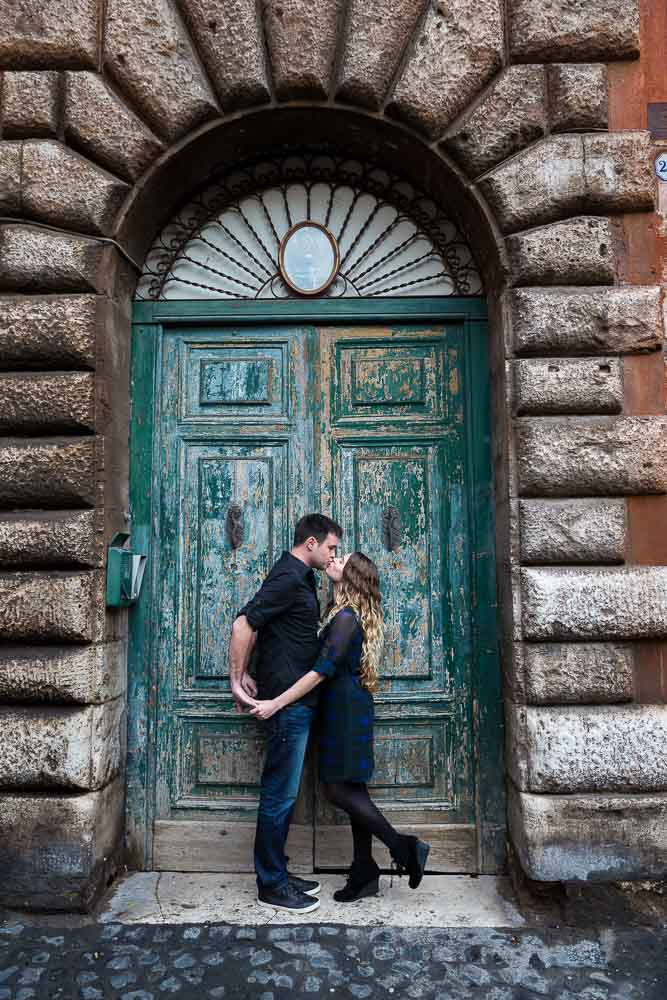 Image of a coupe in love photographed in front of an old roman door