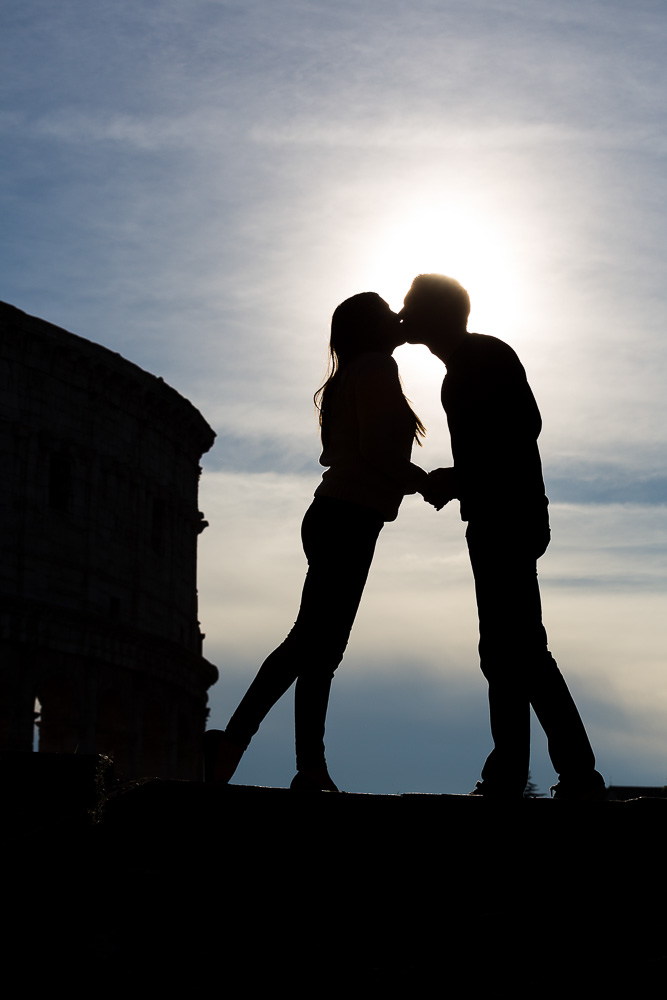 Silhouette picture of an engagement photographed at the Roman Colosseum. Rome, Italy.