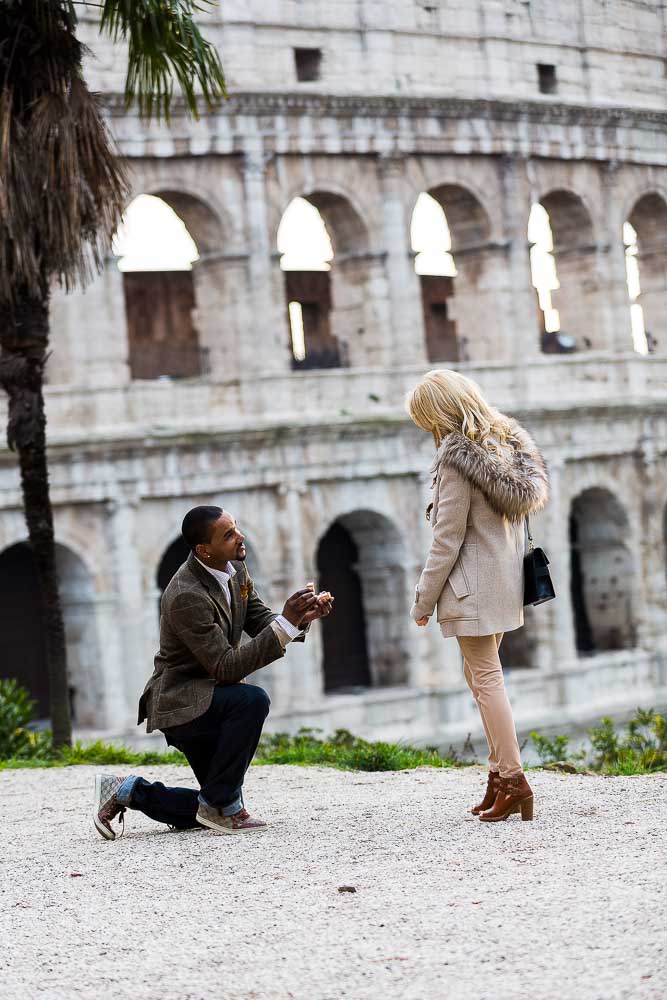 Engagement Proposal. One knee down at the Roman Colosseum.