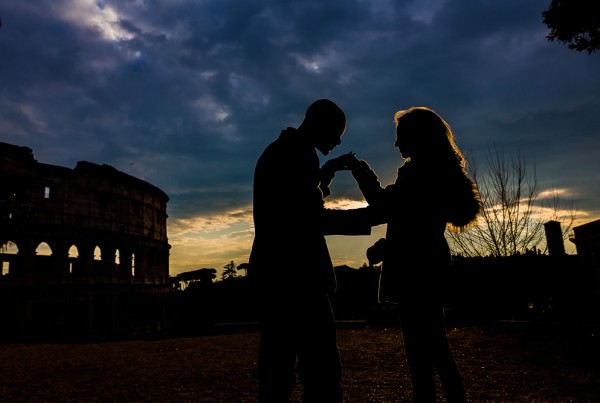 Man kissing the hand of a woman during an e-session