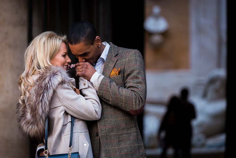 Man kissing the hand of a woman during an engagement photo session