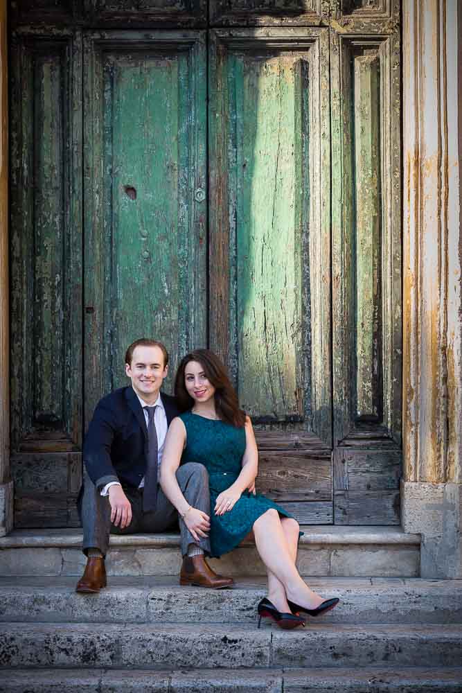 Sitting down snapshot in front of an ancient green door