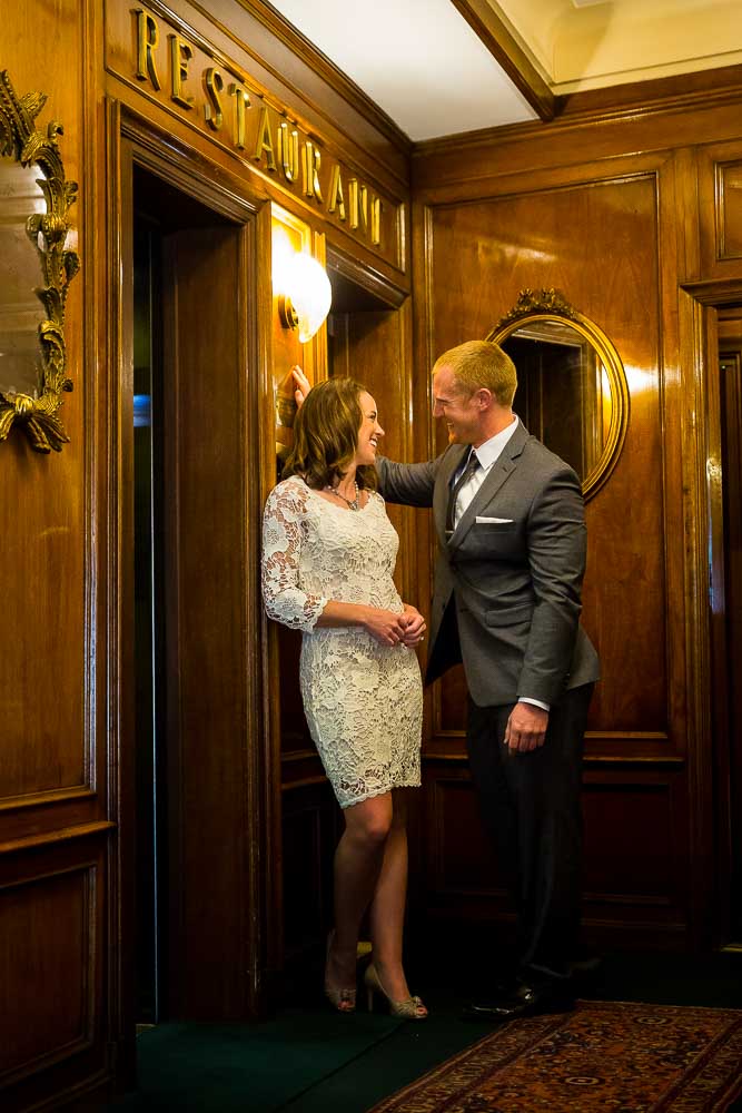 Closeup vertical shot of a couple inside a Hotel romantically standing by an elevator. 