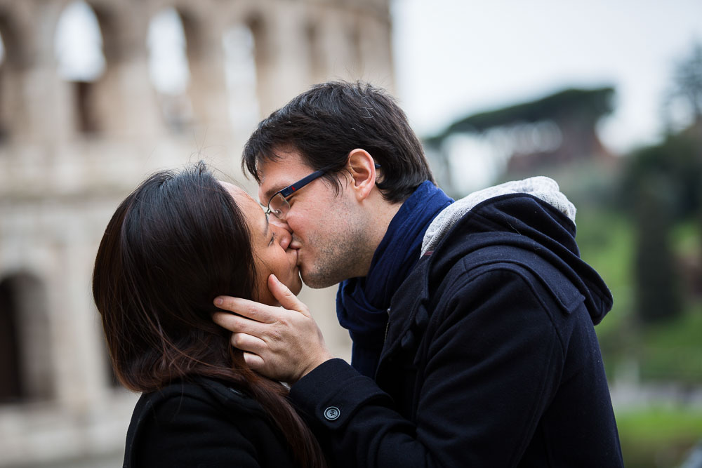 Just engaged. Couple kissing at the Coliseum in Rome