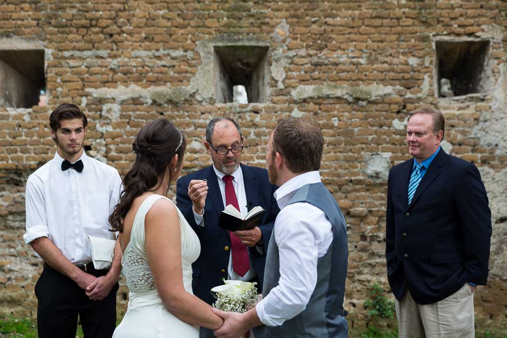 Minister displaying the wedding rings to the couple during a Private Wedding ceremony in Rome