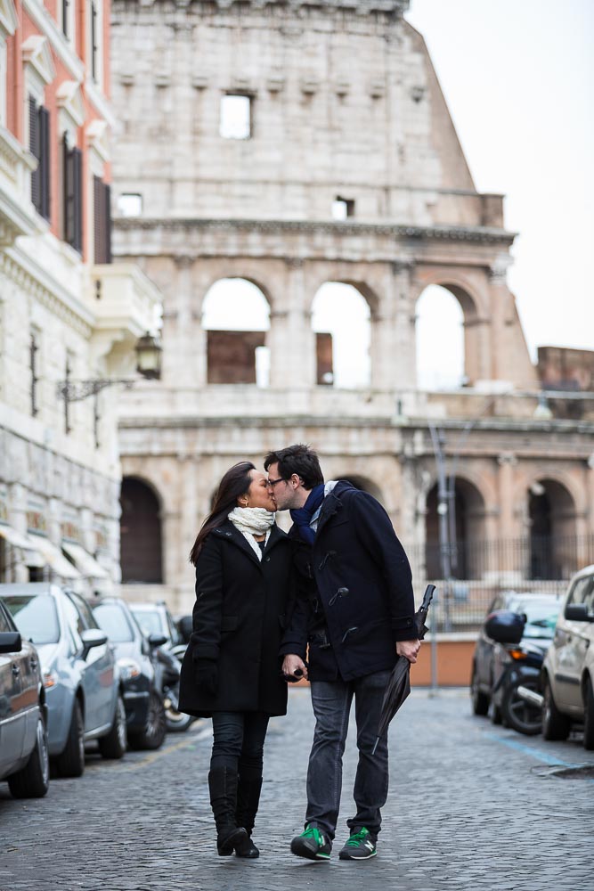 Walking hand in hand in the streets of Rome Italy with the Colosseum in the background