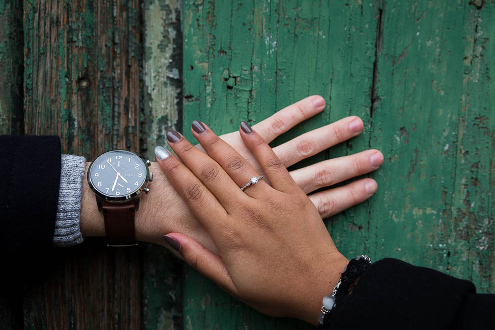 Close up of the engagement ring photographed on an old door