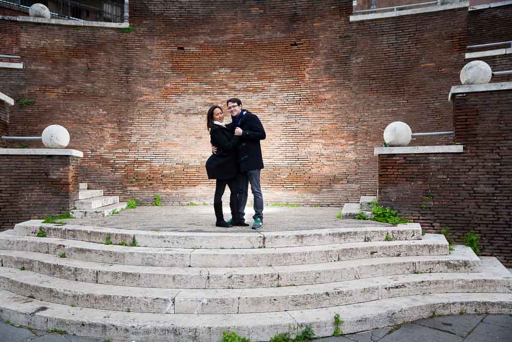 Posing on top of a staircase during an engagement session in Rome