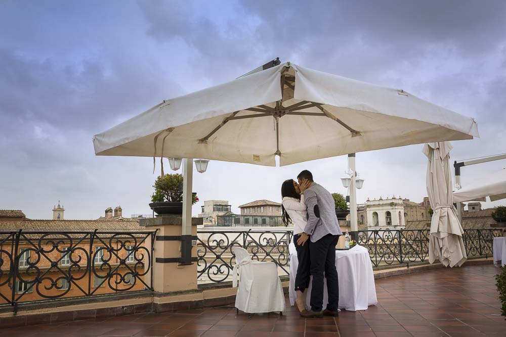 Couple just engaged kissing after the marriage Roof Garden Proposal