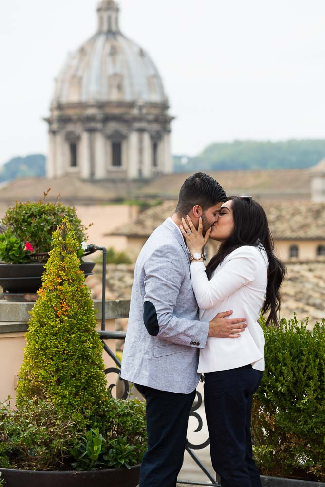 Kissing with the rooftops behind the couple