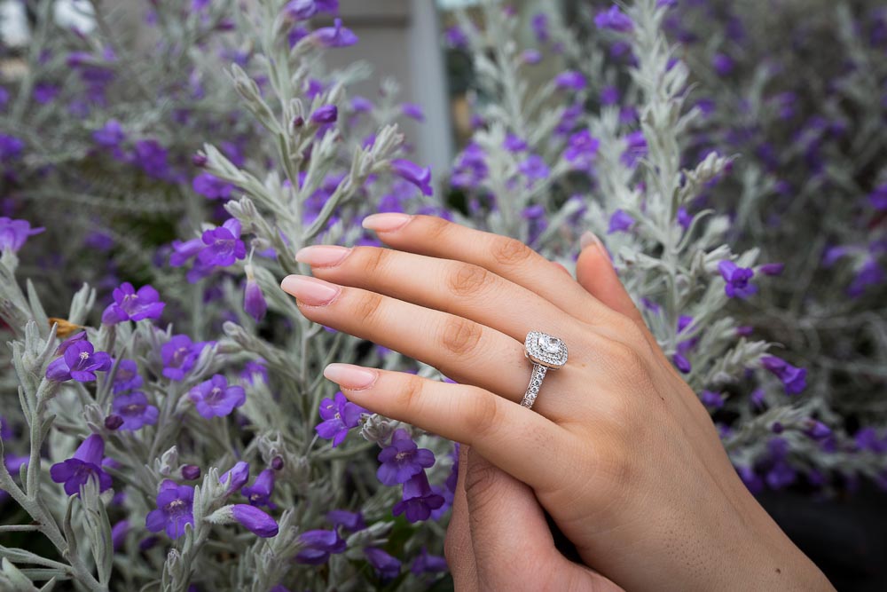 Engagement ring picture of a couple holding hands 