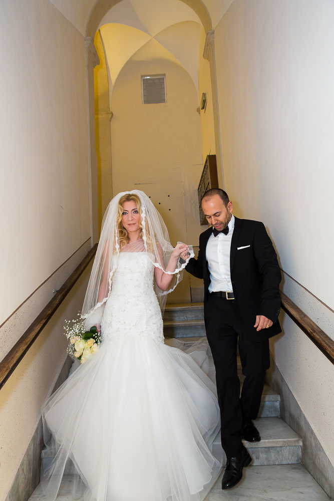 Bride and groom descending stairs