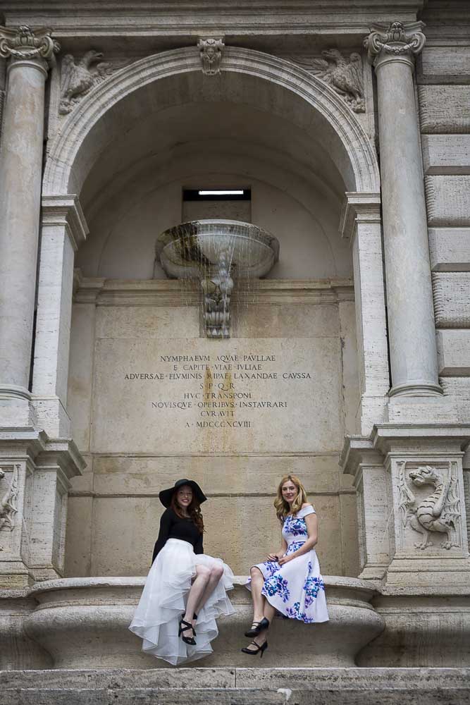 Sitting on the edge of a fountain in Rome during a photography session