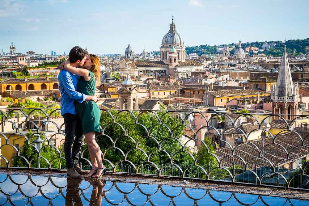 Couple in love kissing before the panoramic view of the city of Rome from above