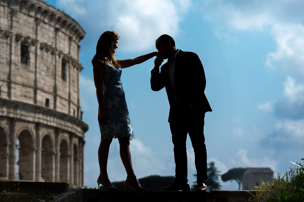 A gentleman's kiss at the Coliseum photographed during an engagement session in Rome Italy