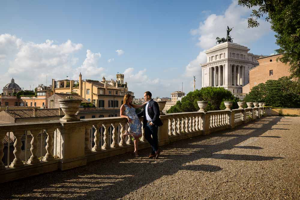 Engaged couple standing by the Vittoriano monument