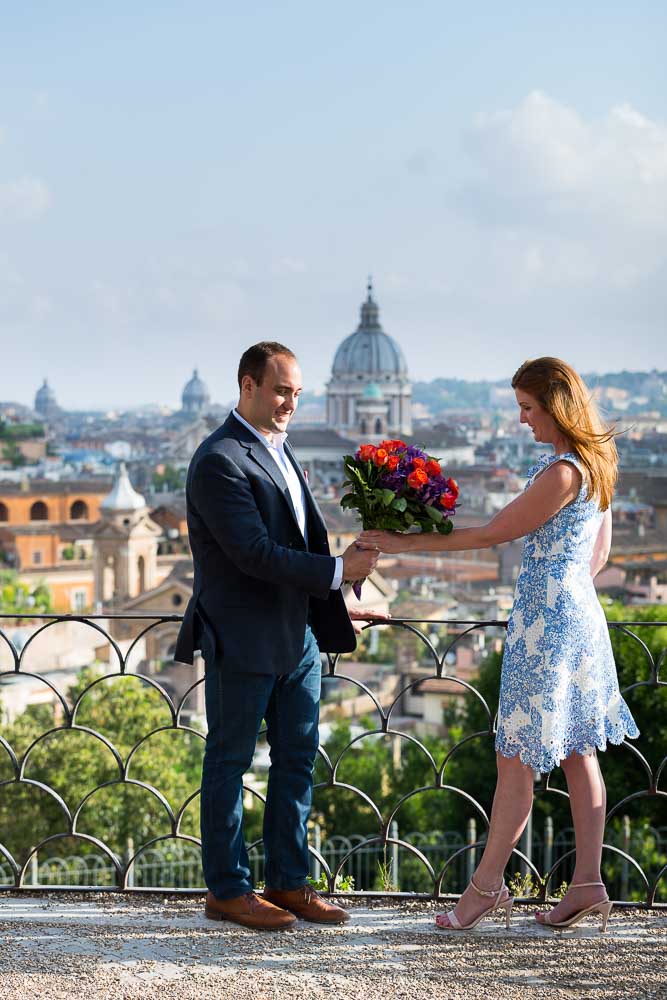 Red flowers during an engaged pictures session at Parco del Pincio