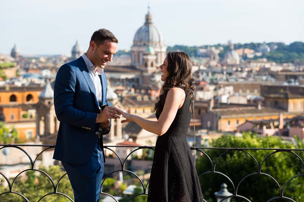 Just engaged couple. Putting the engagement ring on. Romantic proposal in Rome