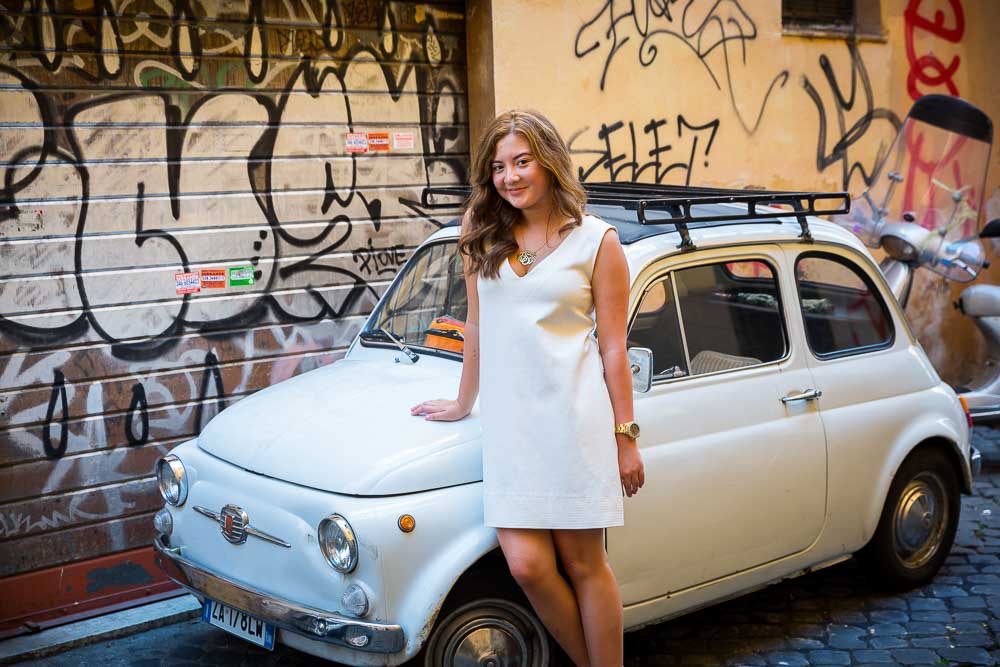 Leaning into a white fiat 500 car