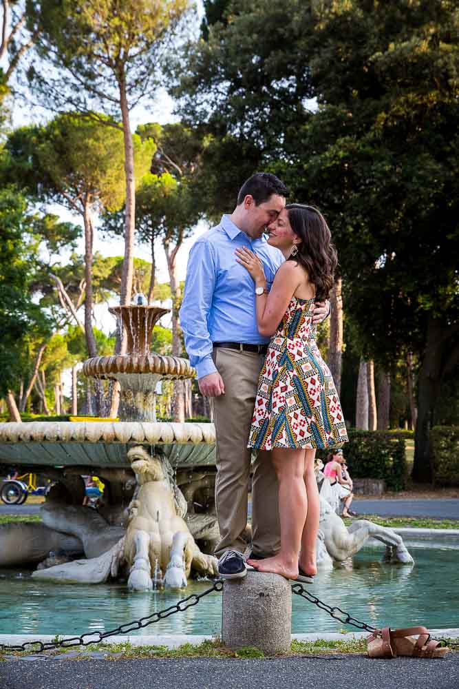 Standing on a pillar and taking engagement pictures with a photographer