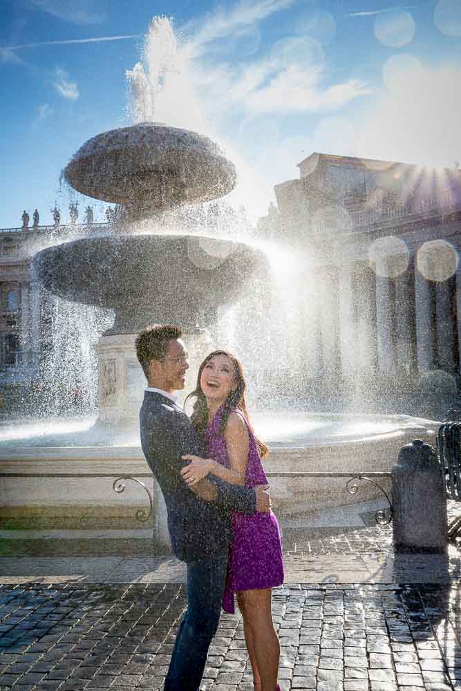 Splashing water from fountain at the Vatican square. Engagement photographer Andrea Matone Rome Italy.