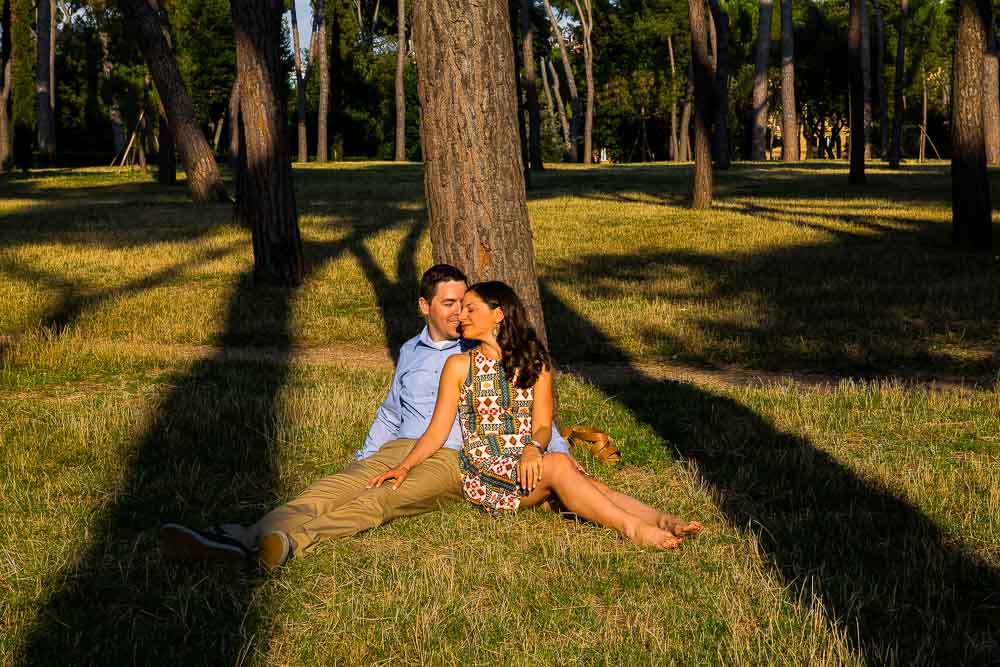 Laying down on the grass by a tree in Park Villa Borghese in Rome Italy.