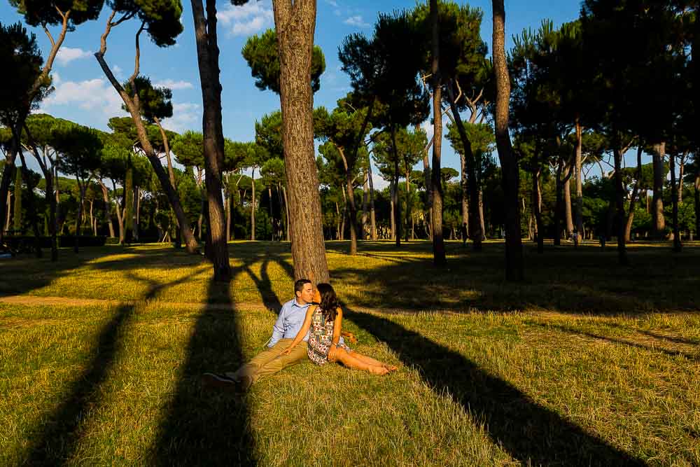 Laying down on the grass by a tree in Park Villa Borghese in Rome Italy. Image by Andrea Matone photographer