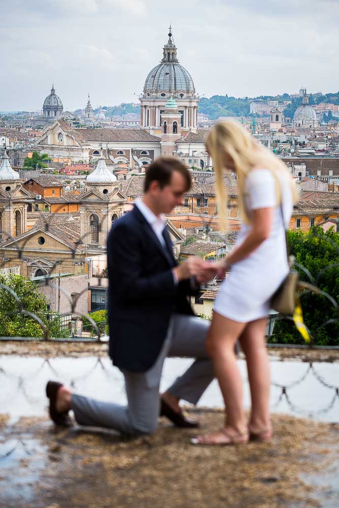 Man asking fiancee for marriage in Rome. Soft focus effect.