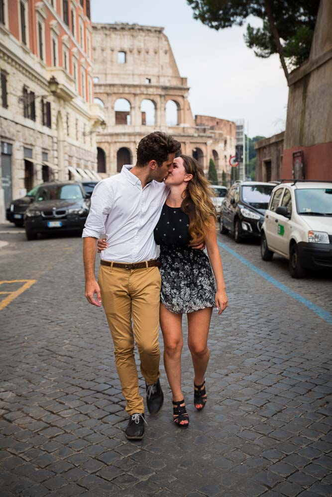 Engagement session in Rome: couple kissing as they walk the streets