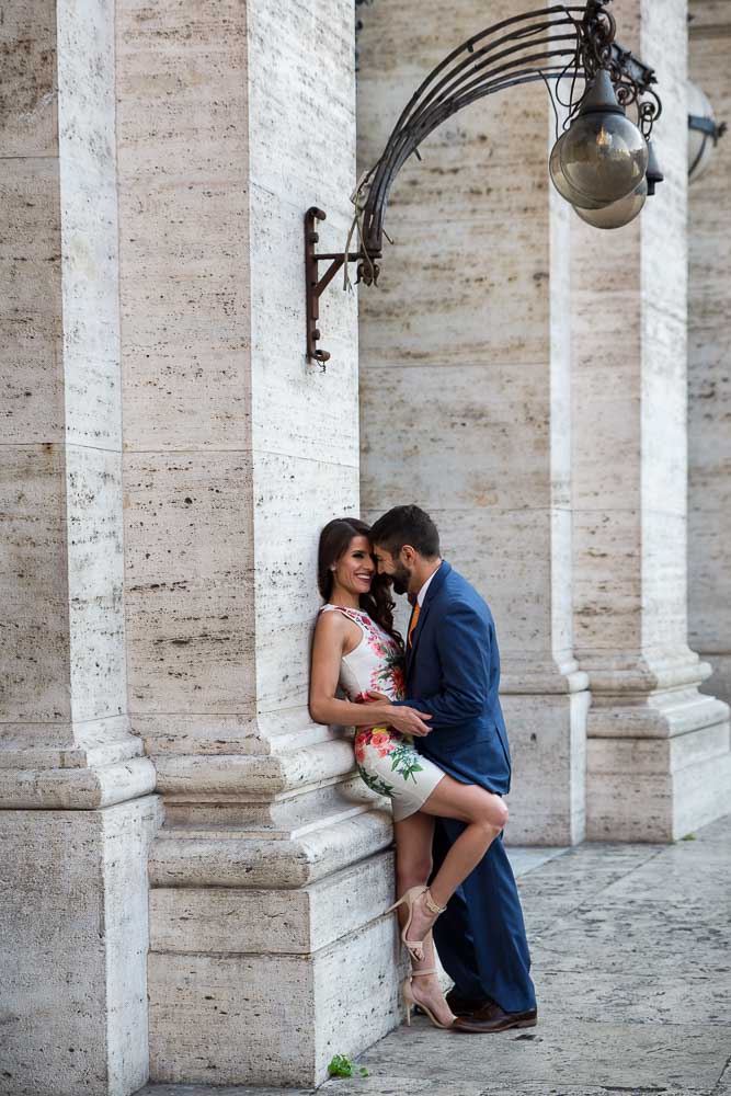 Couple in love leaning on the Piazza della Repubblica columns