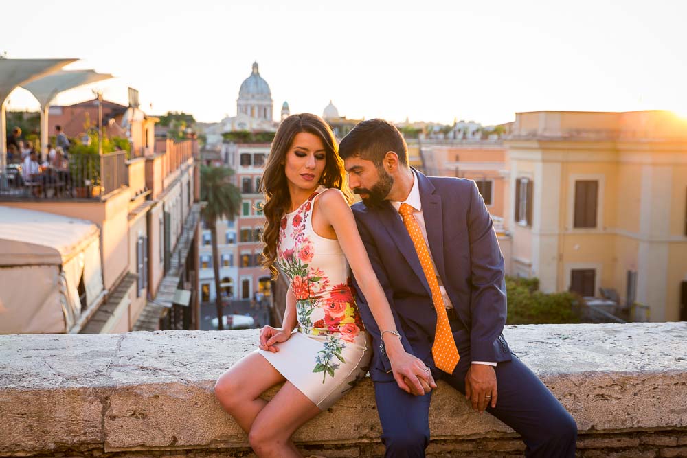 Kissing during an engagement style session in Rome at sun set