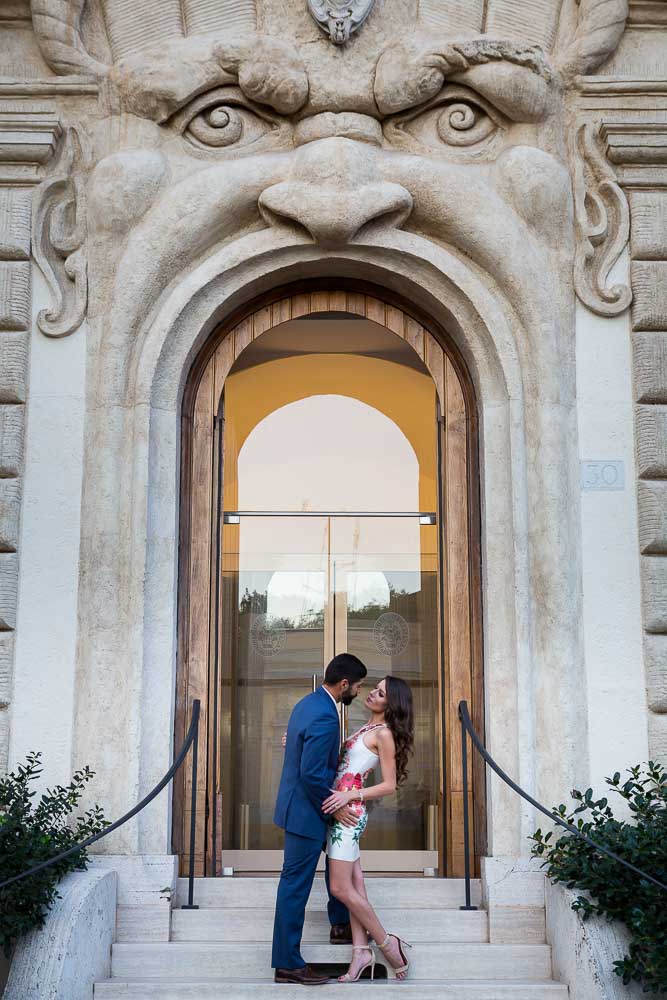 Romantic and love picture of a couple standing in front of a interesting mouth like door entrance