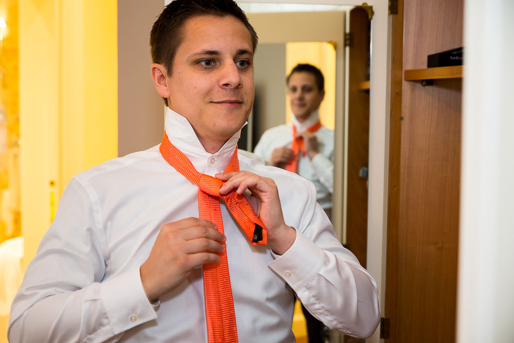 Groom preparation. Putting on the tie