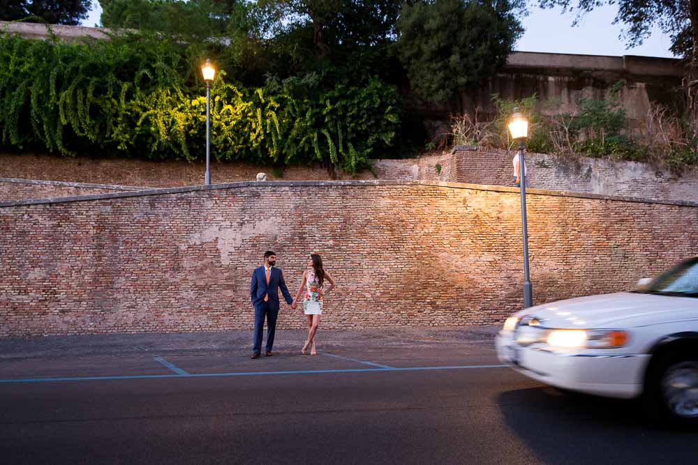 Holding hands at Parco del Pincio while cars are driving by