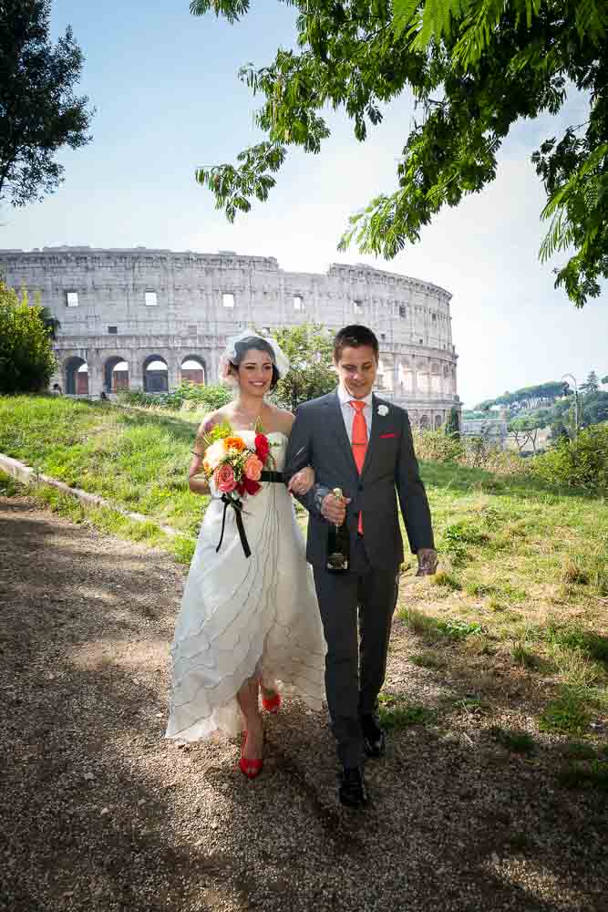 Wedding couple descending hill at the Coliseum in Rome