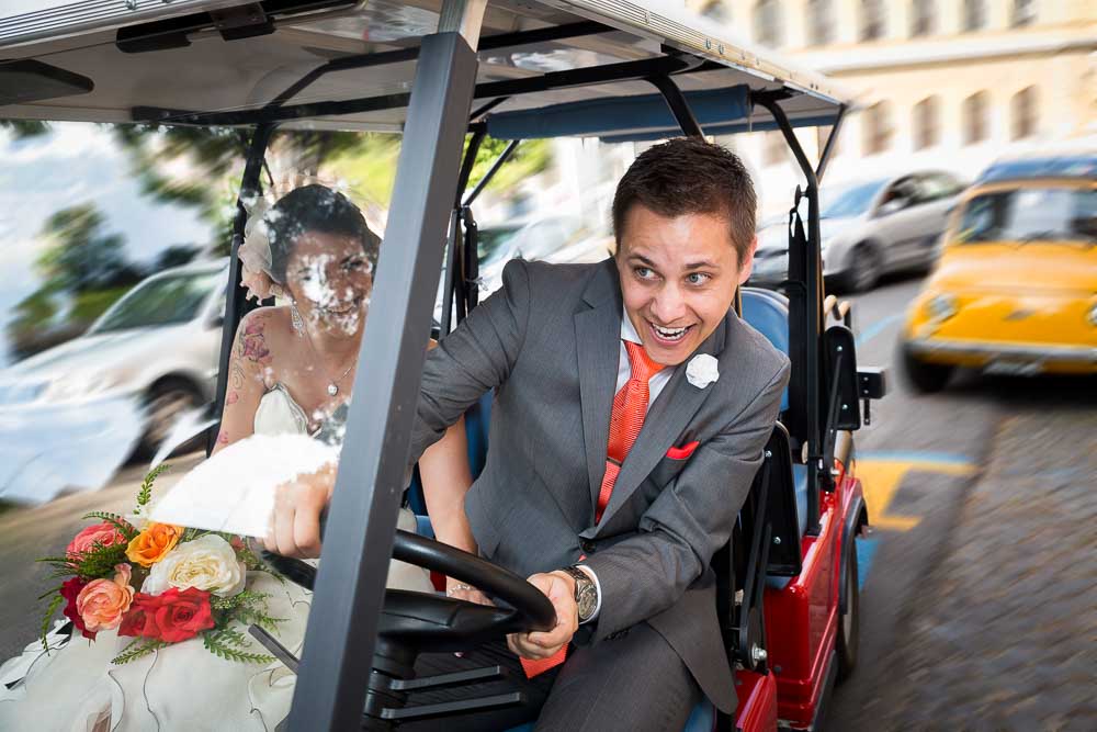 Groom driving a golf cart in between traffic