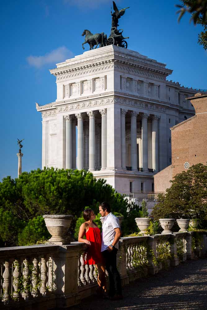 Couple posing in front of the Vittoriano monument in the distance
