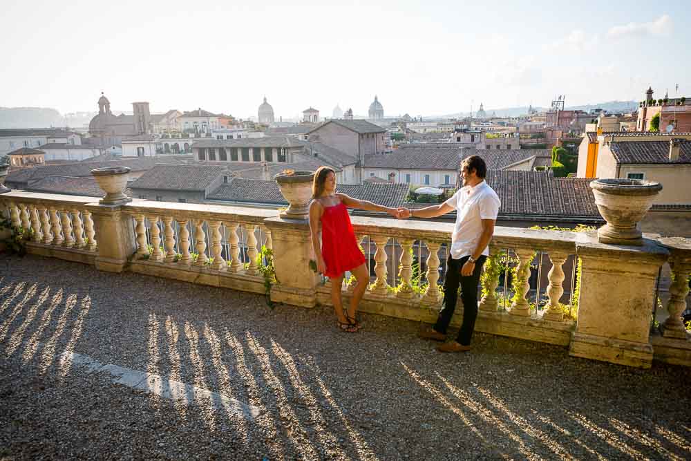 Holding hands photo shoot overlooking the roman rooftops at sunset