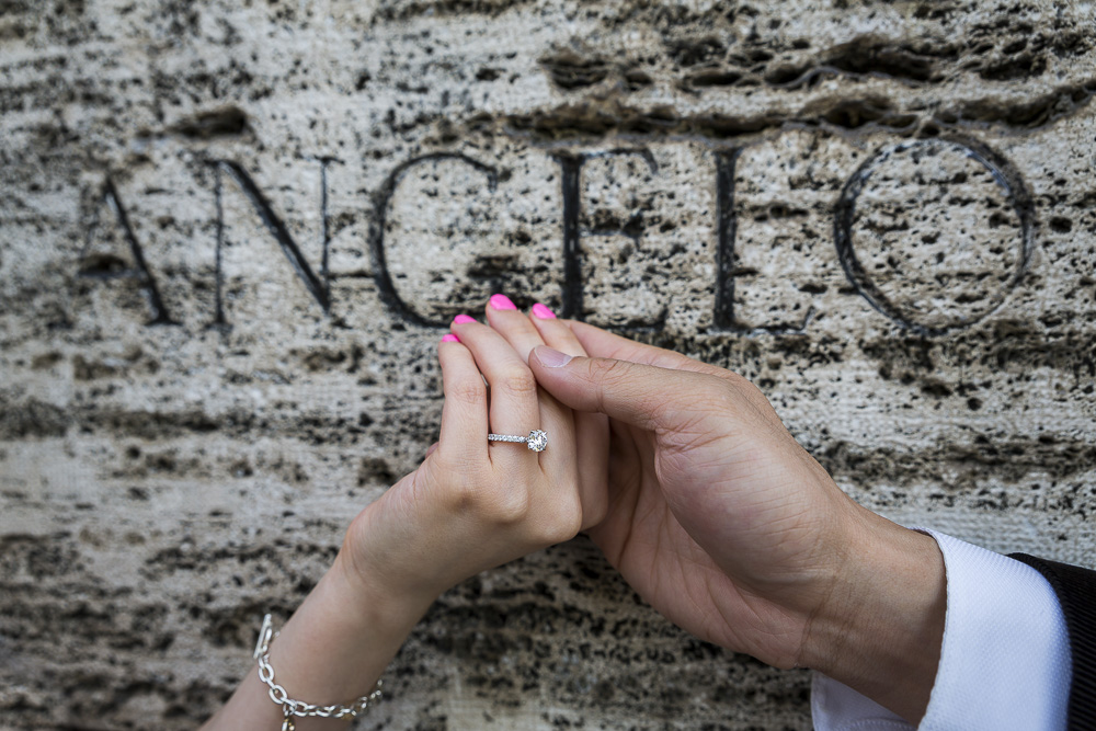 Close up shot of the engagement ring photographed on ancient roman marble