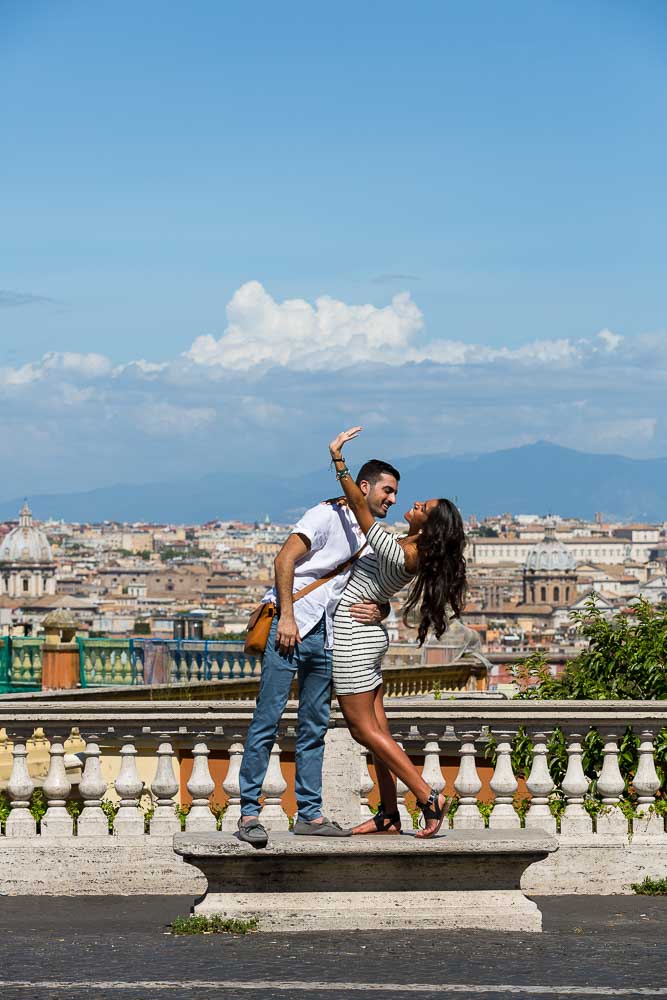 Showing the engagement ring to the sky during a photography session in Rome Italy