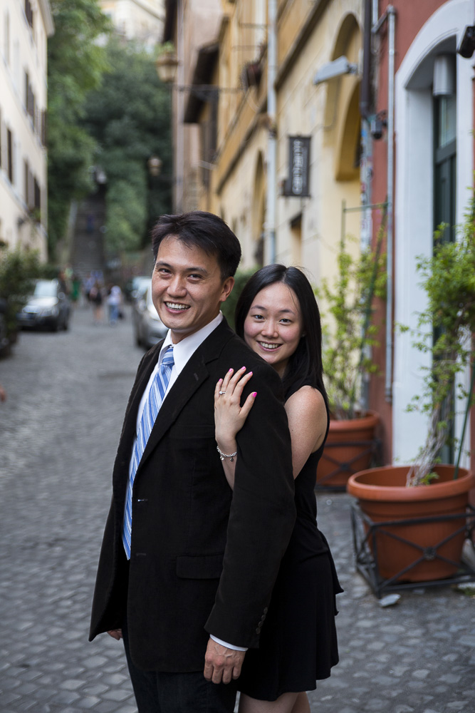 Portrait shot of a man and a woman during their engagement in Trastevere Rome. Alleyway streets setting. 