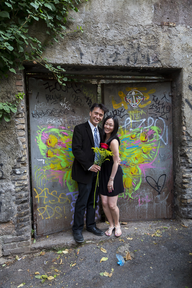 Standing together with flowers in front of a door with colorful angel wings